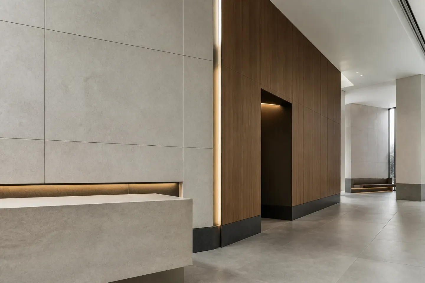 Commercial reception interior with large-format pale wall panels, timber lining, dark impact plinths and metal reveals.