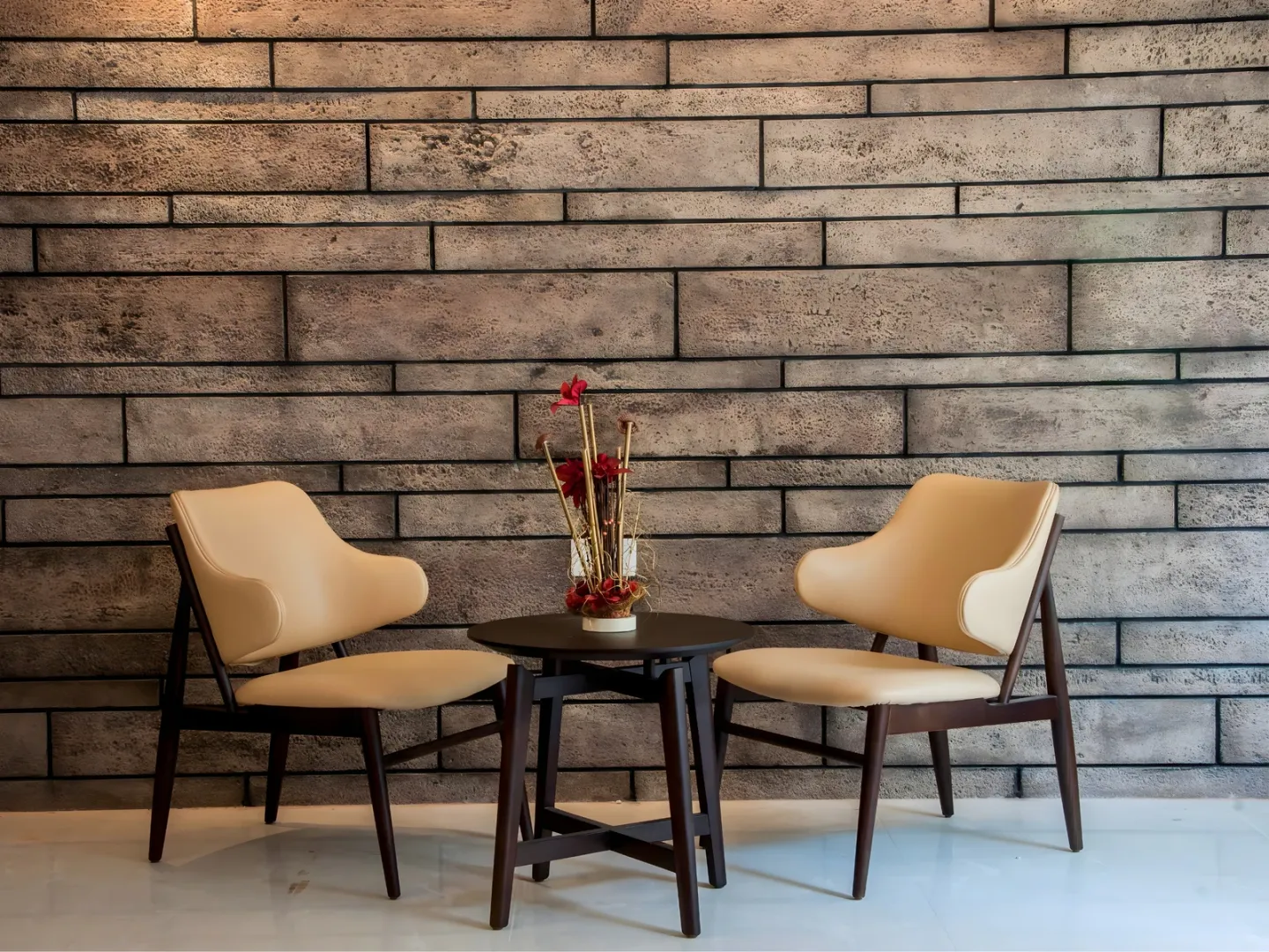 Textured brick feature wall behind a small seating area.
