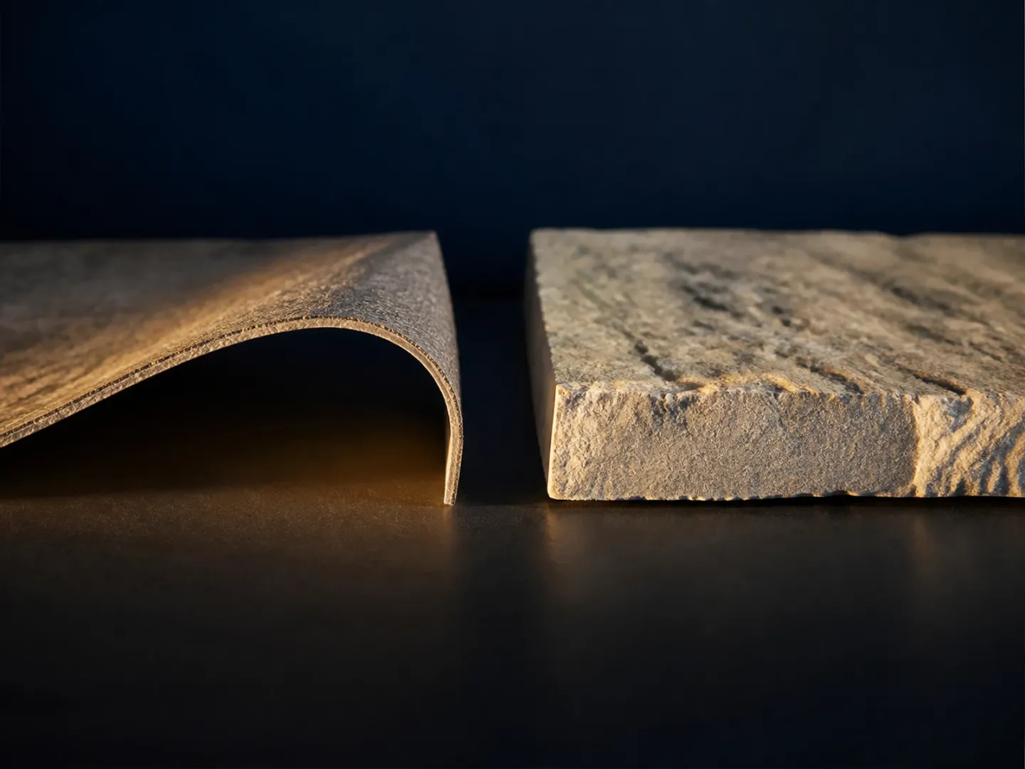 Thin flexible stone sheet beside a thick rigid stone veneer slab.