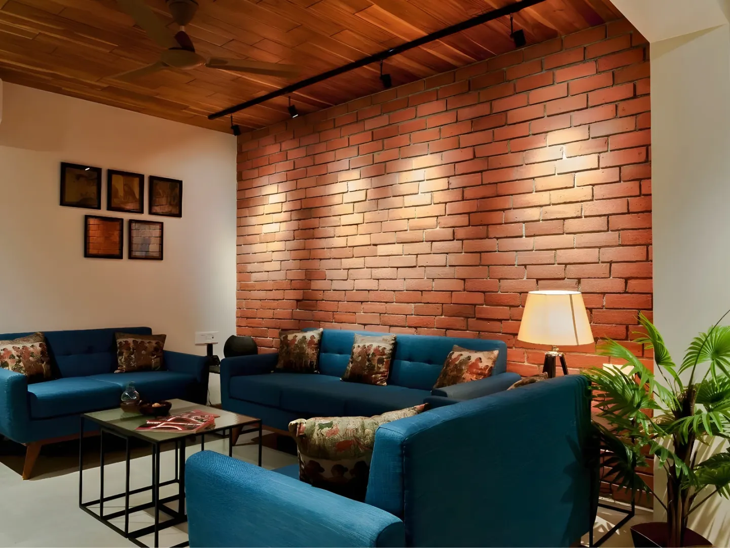 Warm room combining red brick walls, a timber ceiling and painted surfaces.