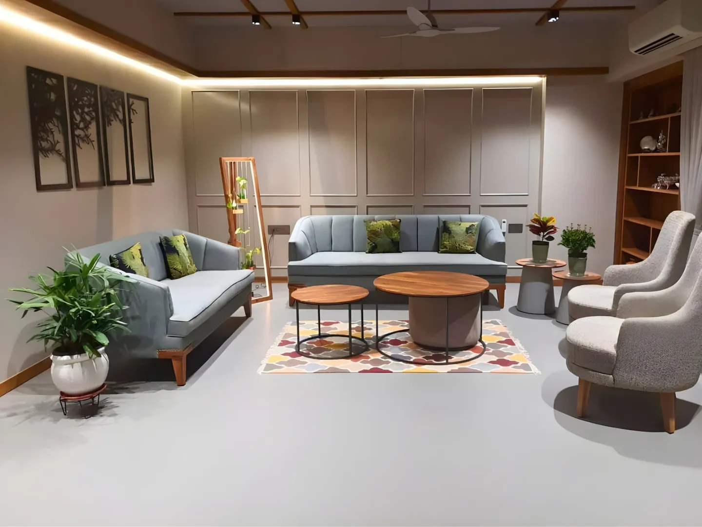 Furnished living room with paneled walls, built-in shelving and layered lighting.