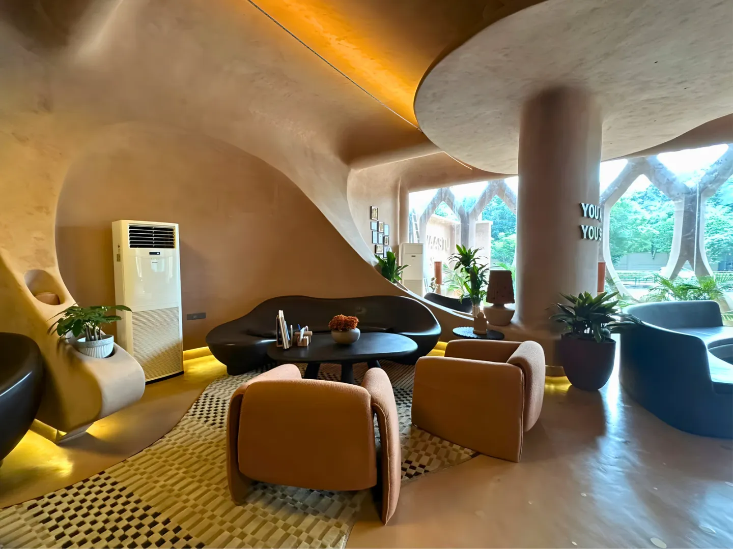 Sculpted interior with continuous curved plaster walls, ceilings and columns.